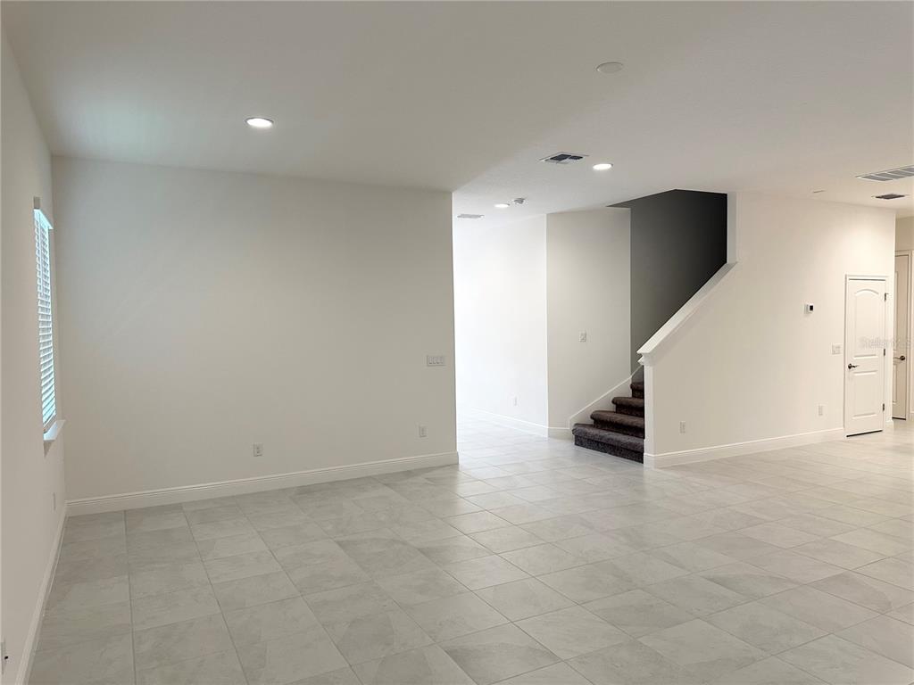 5282 Buttonsage Drive St. Cloud, FL 34772 - Photo 10 of 43 wooden floor in an empty room with a window