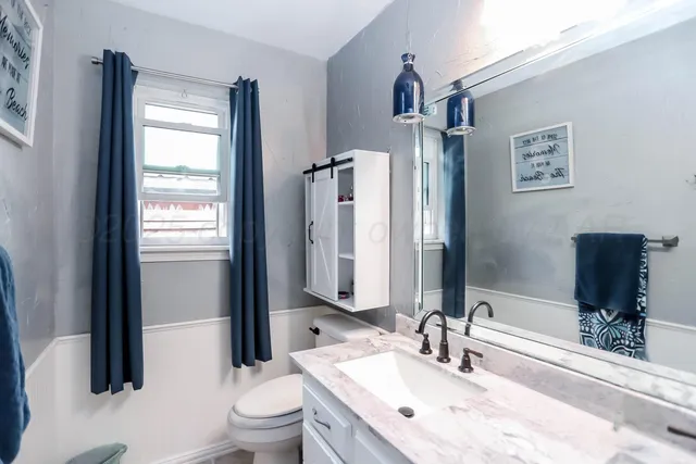 a living room with furniture a window and wooden floor