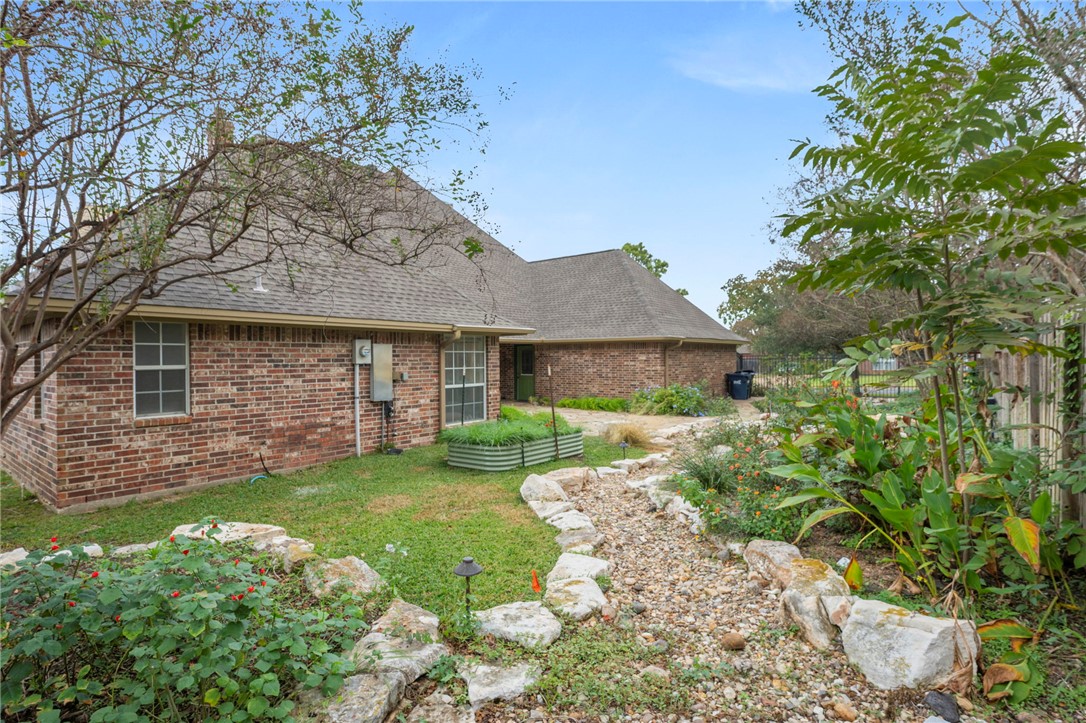 713 Willow Loop College Station, TX 77845 - Photo 34 of 39 a front view of a house with a garden