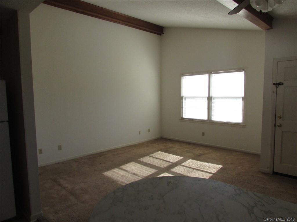 6012 Pleasant Grove Road Charlotte, NC 28216 - Photo 3 of 13 an empty room with windows