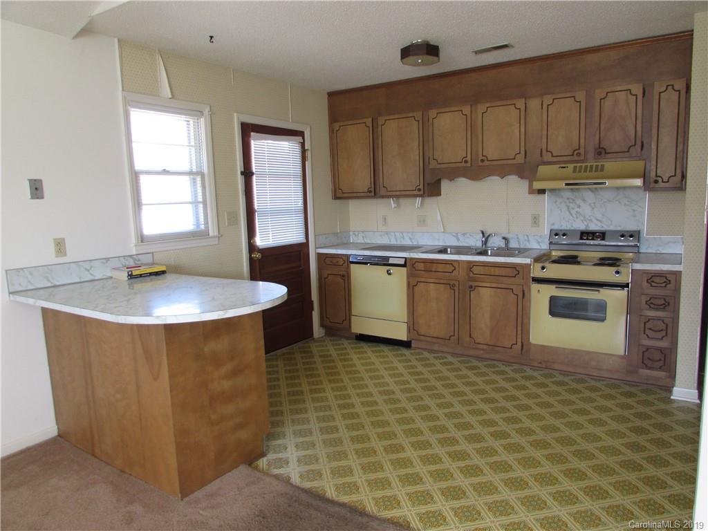 6012 Pleasant Grove Road Charlotte, NC 28216 - Photo 5 of 13 a kitchen with stainless steel appliances granite countertop a sink a stove and a granite counter tops