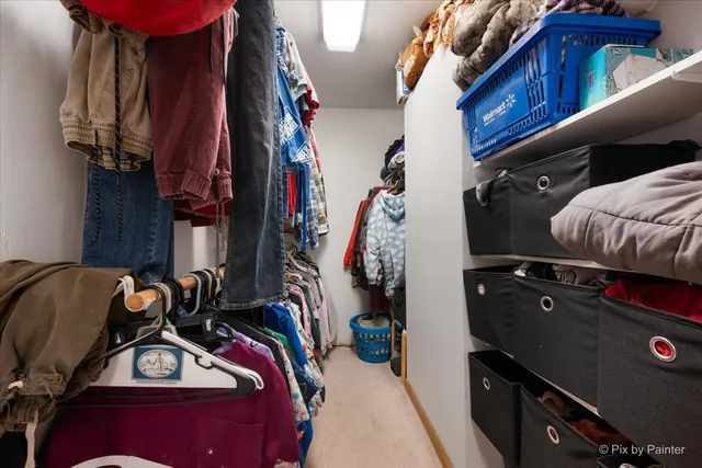 a view of walk in closet with clothes