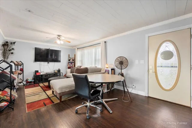 a living room with furniture a flat screen tv and a window