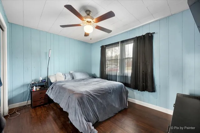 a bedroom with a large bed and a large window