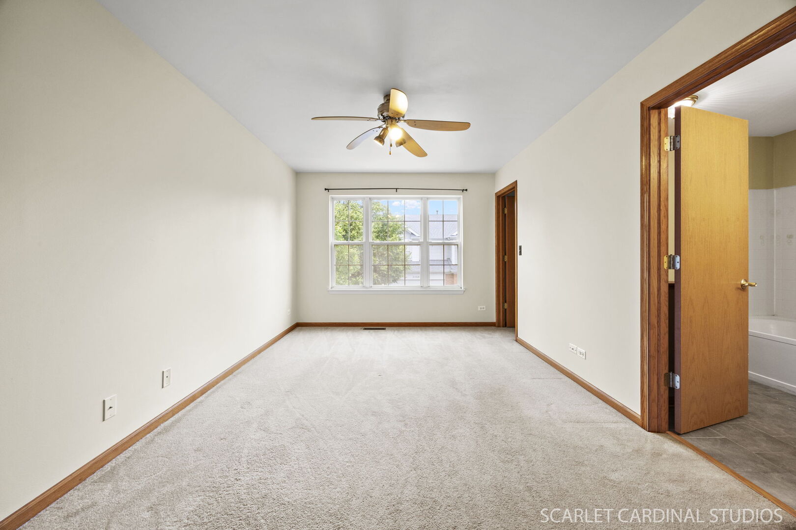 2242 Foxmoor Lane, Unit 2242 Aurora, IL 60502 - Photo 13 of 20 an empty room with windows closet and chandelier fan