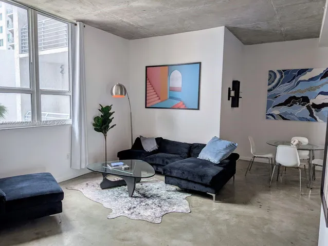 a living room with furniture and a potted plant