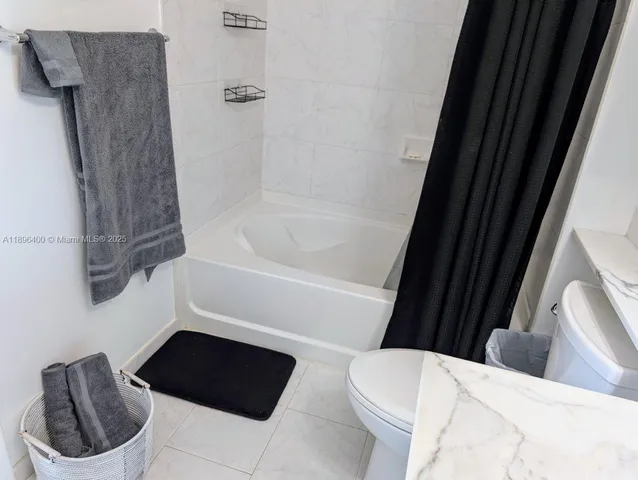 a bathroom with a toilet and a bathtub