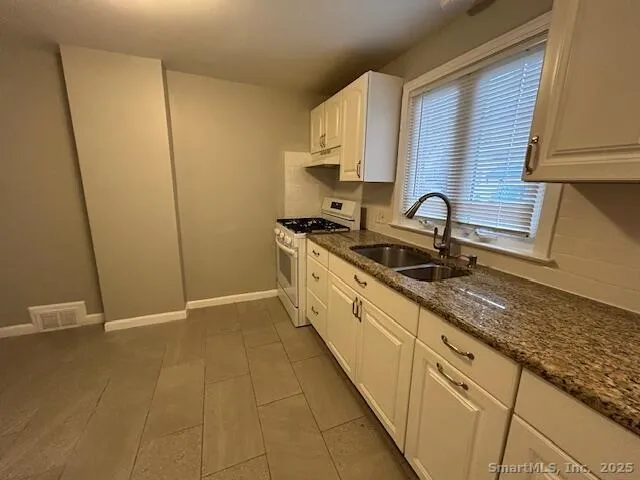 a kitchen with a sink and cabinets