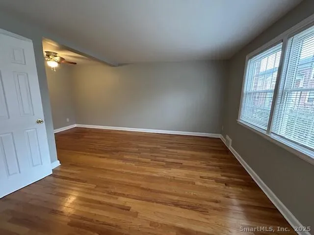 wooden floor in an empty room with a window