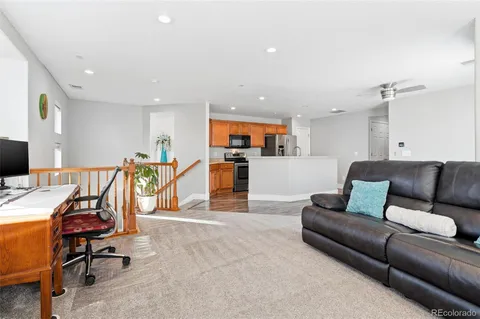 a living room with furniture and kitchen view