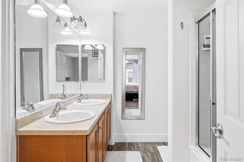 a bathroom with a sink a vanity a mirror and shower