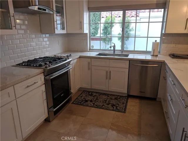 a kitchen with a stove a sink and a microwave