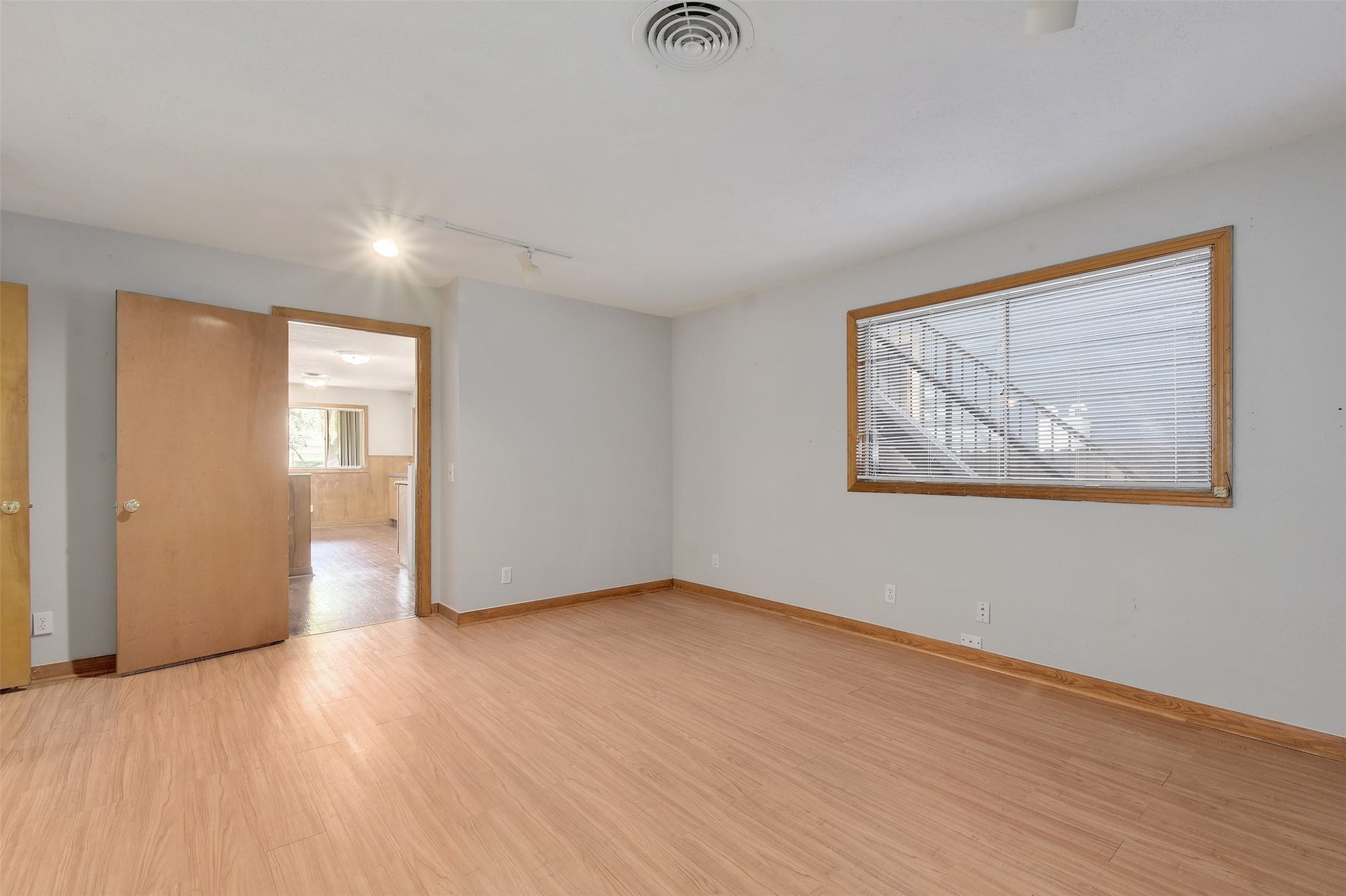 4306 Avenue B Austin, TX 78751 - Photo 18 of 34 a view of an empty room with wooden floor and a window