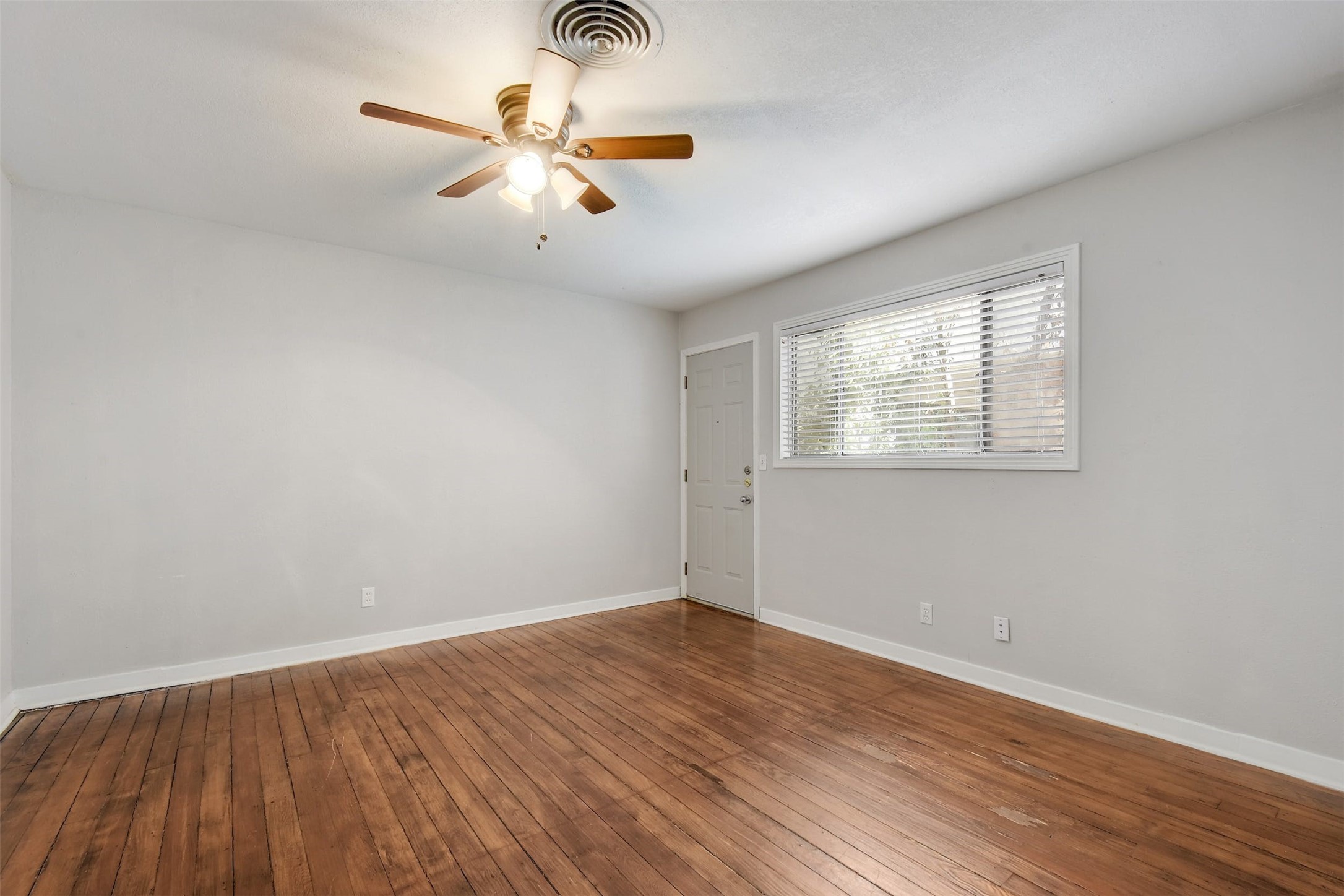 4306 Avenue B Austin, TX 78751 - Photo 21 of 34 an empty room with wooden floor fan and windows