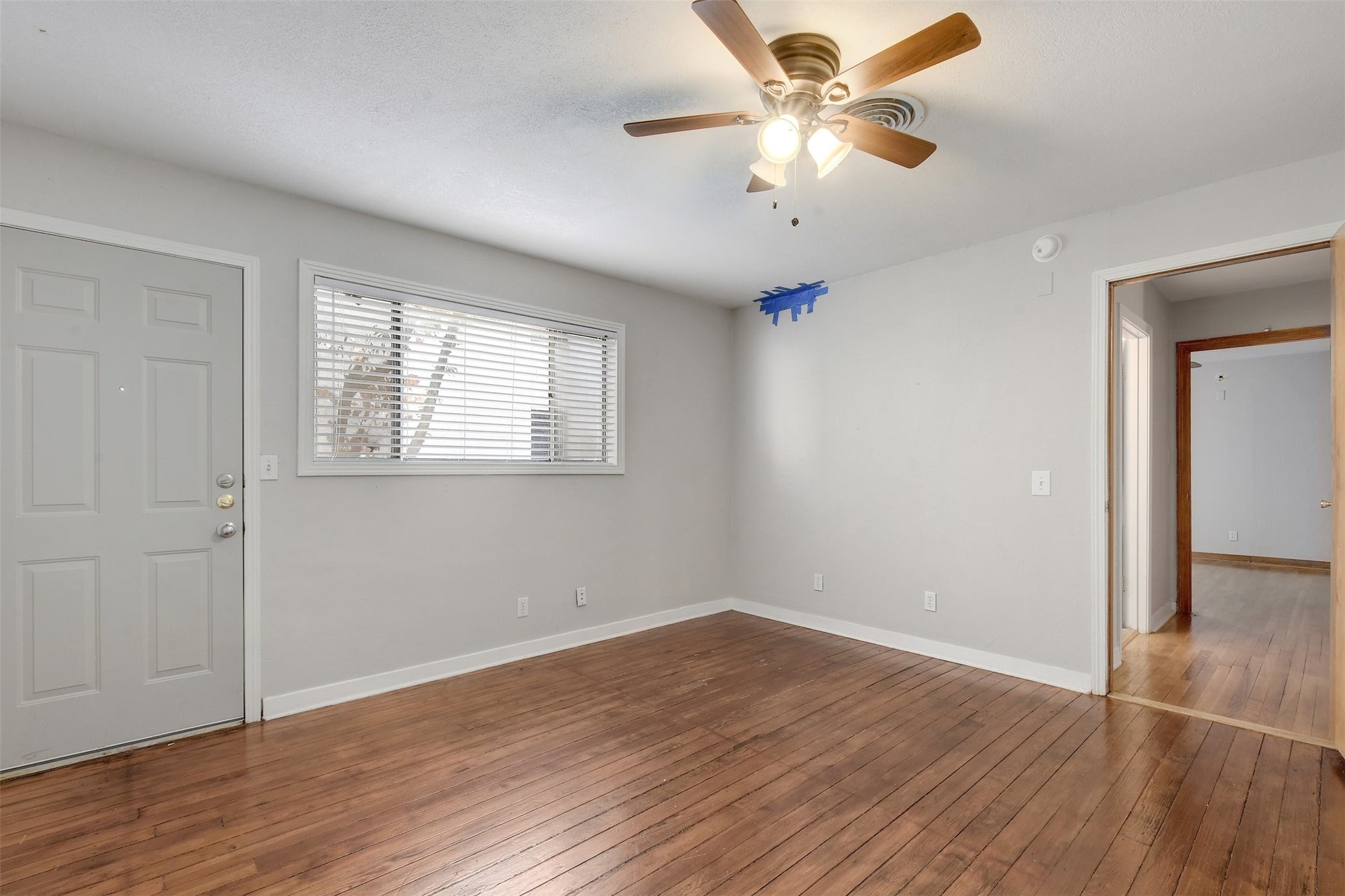 4306 Avenue B Austin, TX 78751 - Photo 22 of 34 an empty room with wooden floor fan and windows