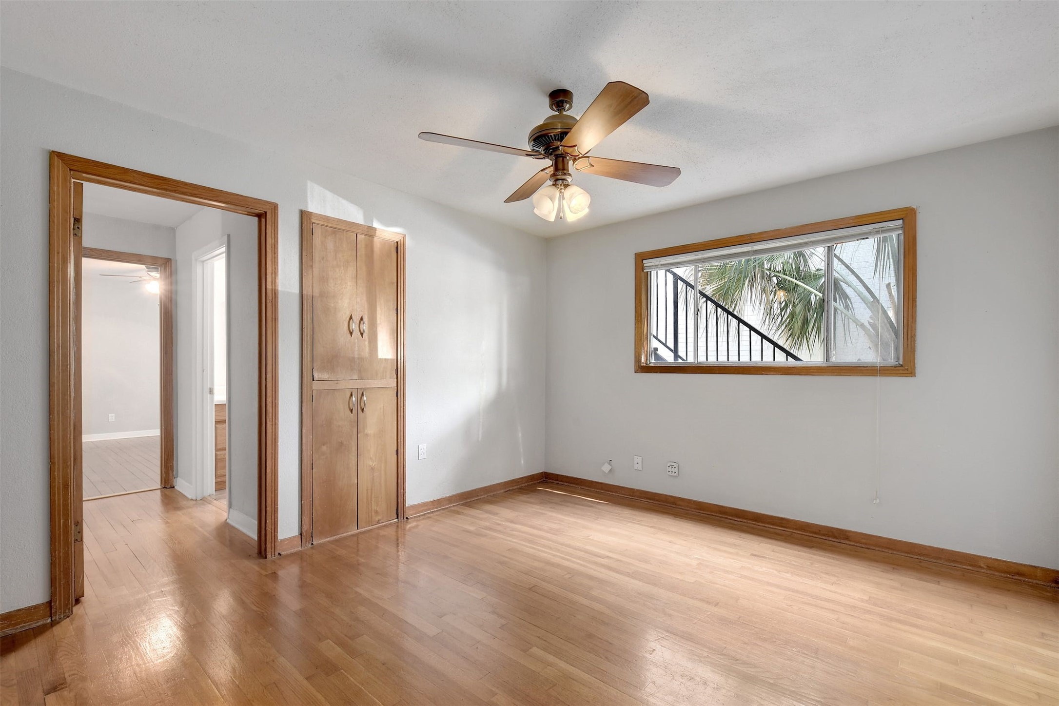 4306 Avenue B Austin, TX 78751 - Photo 23 of 34 a view of an empty room with wooden floor and a ceiling fan