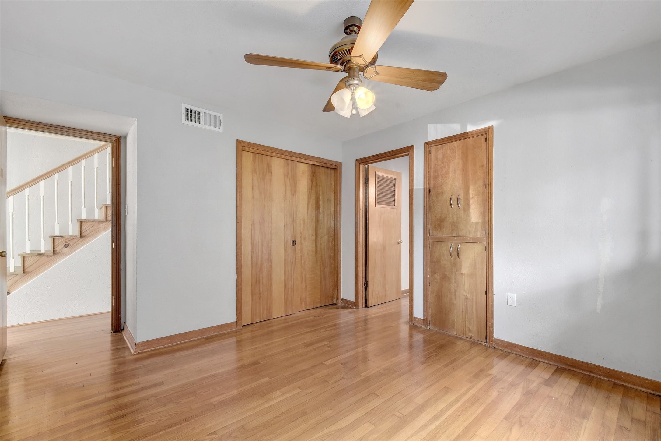 4306 Avenue B Austin, TX 78751 - Photo 24 of 34 a view of an empty room with wooden floor and a ceiling fan