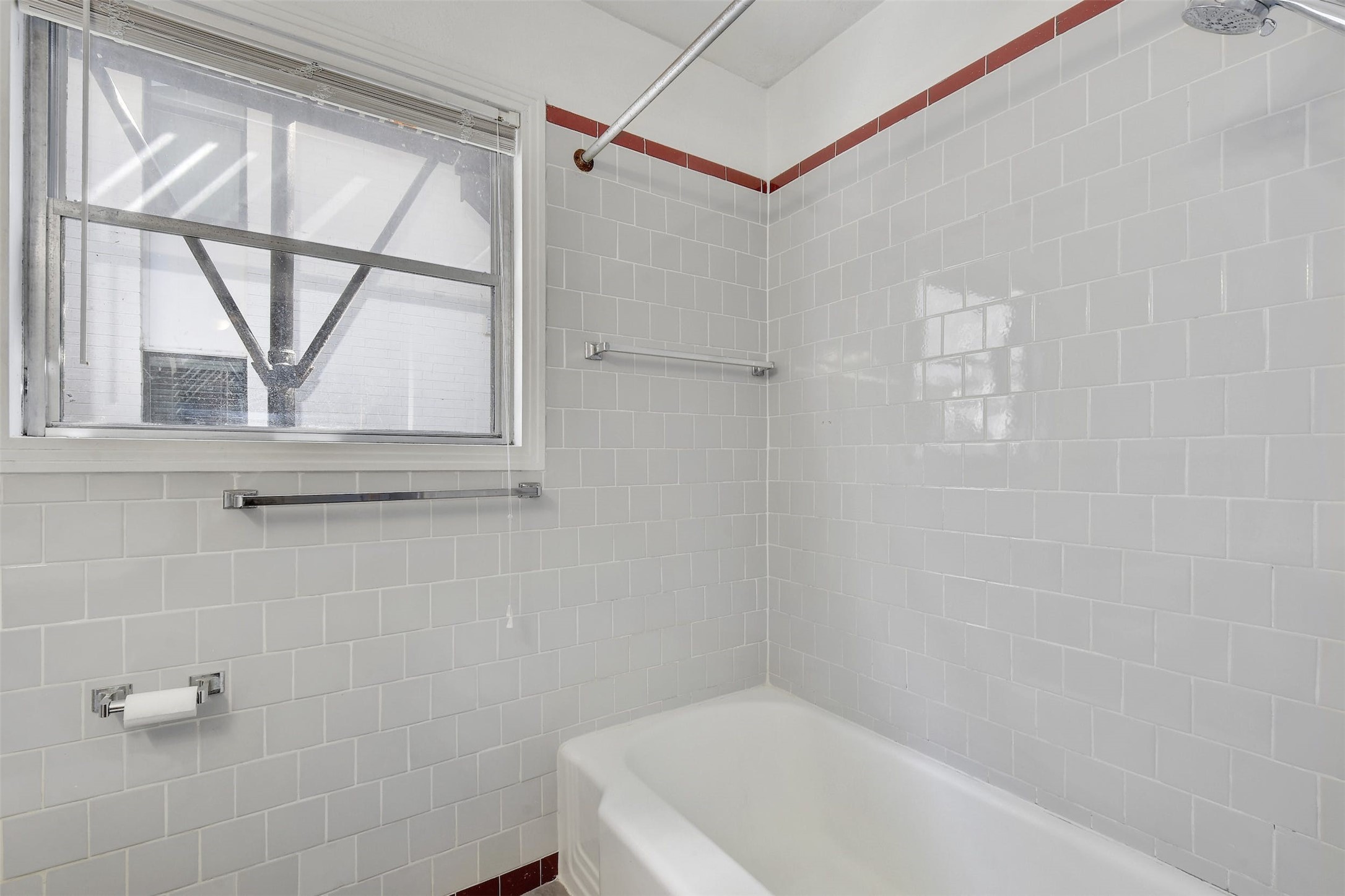 4306 Avenue B Austin, TX 78751 - Photo 26 of 34 a bathroom with a tub a window and a shower
