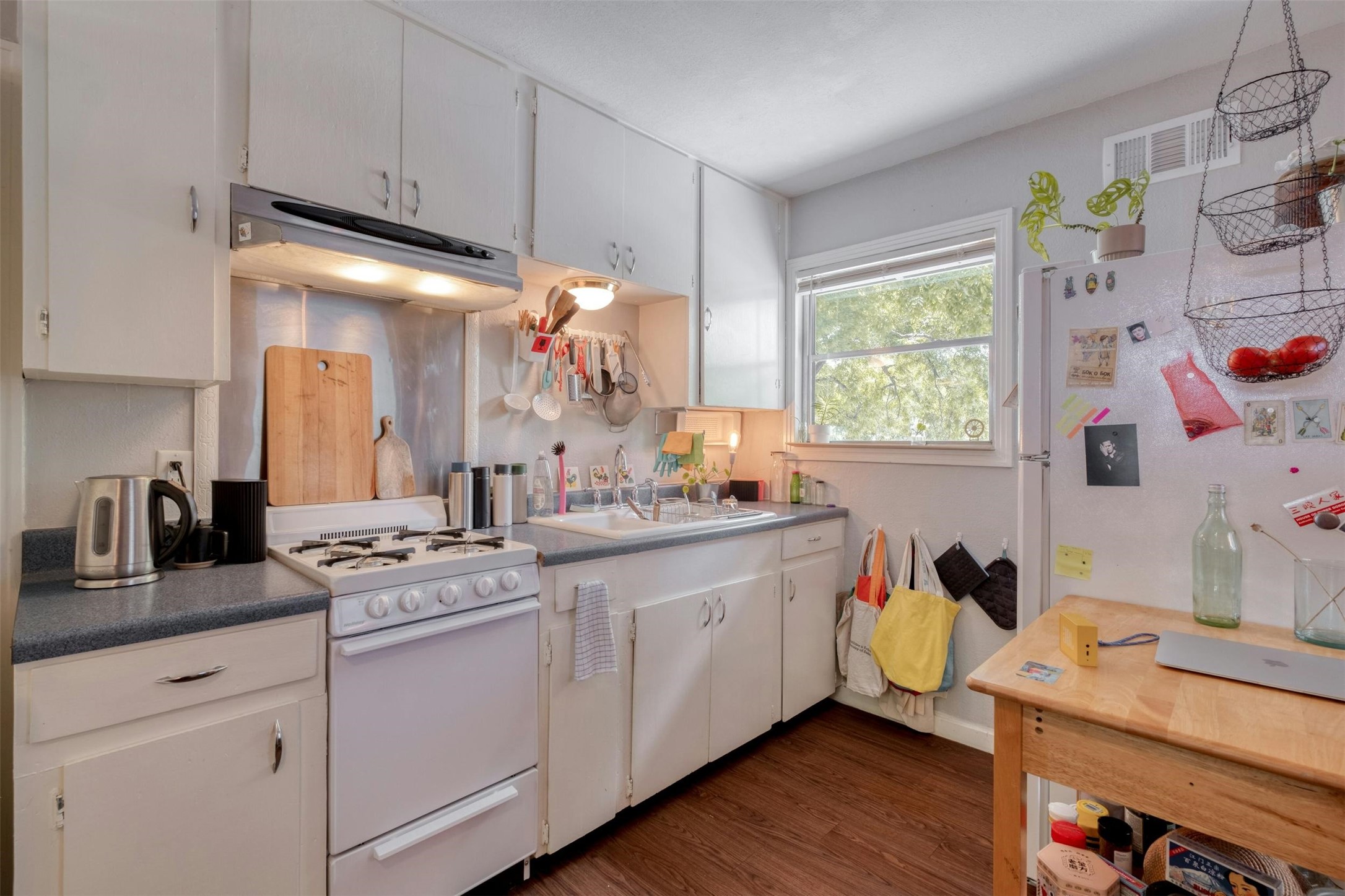 4306 Avenue B Austin, TX 78751 - Photo 29 of 34 a kitchen with a sink cabinets and wooden floor
