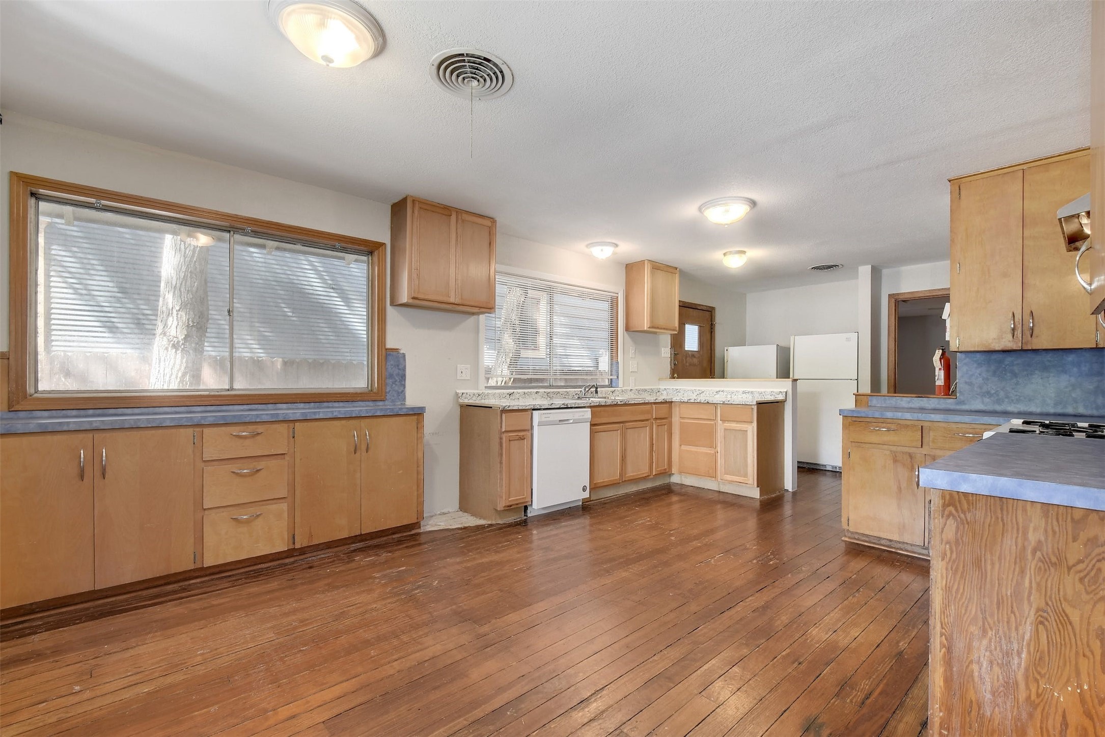 4306 Avenue B Austin, TX 78751 - Photo 7 of 34 a kitchen with stainless steel appliances wooden floors and white cabinets