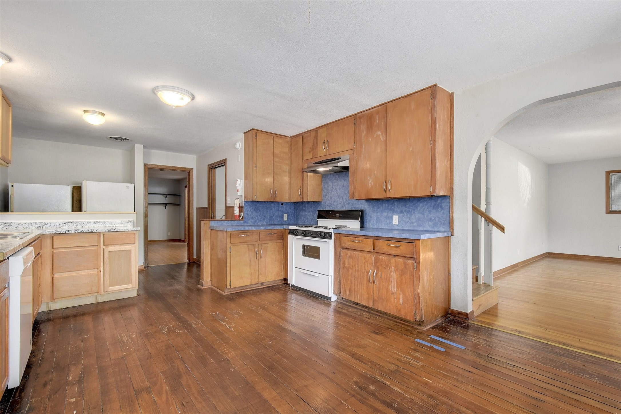 4306 Avenue B Austin, TX 78751 - Photo 8 of 34 a kitchen with granite countertop wooden floors and white stainless steel appliances