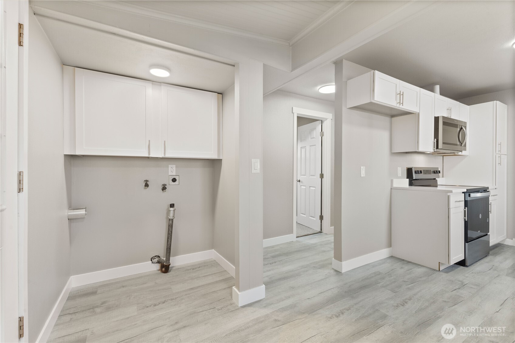 639 Elizabeth Street Sumner, WA 98390 - Photo 11 of 26 a view of a kitchen with a sink and a refrigerator