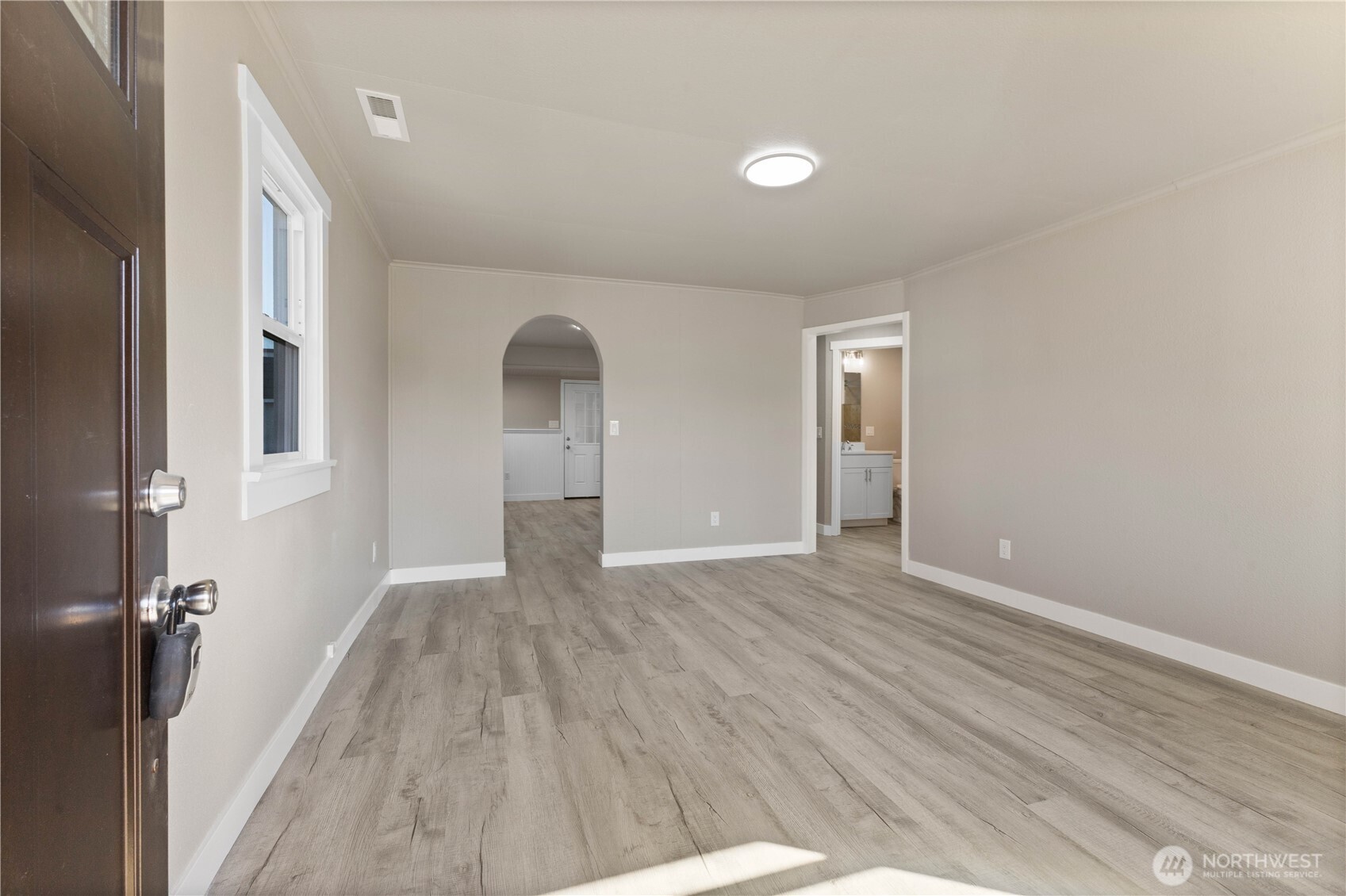 639 Elizabeth Street Sumner, WA 98390 - Photo 4 of 26 wooden floor in an empty room with a window