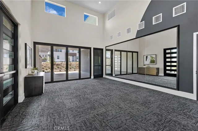 a view of an empty room with window and cabinet