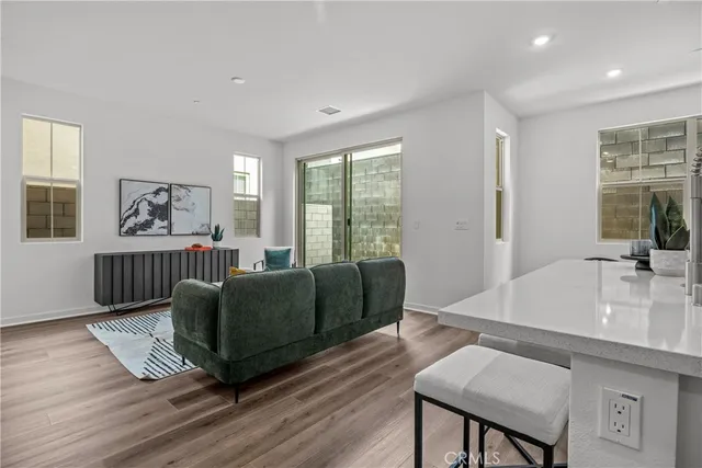a kitchen with appliances cabinets and chair