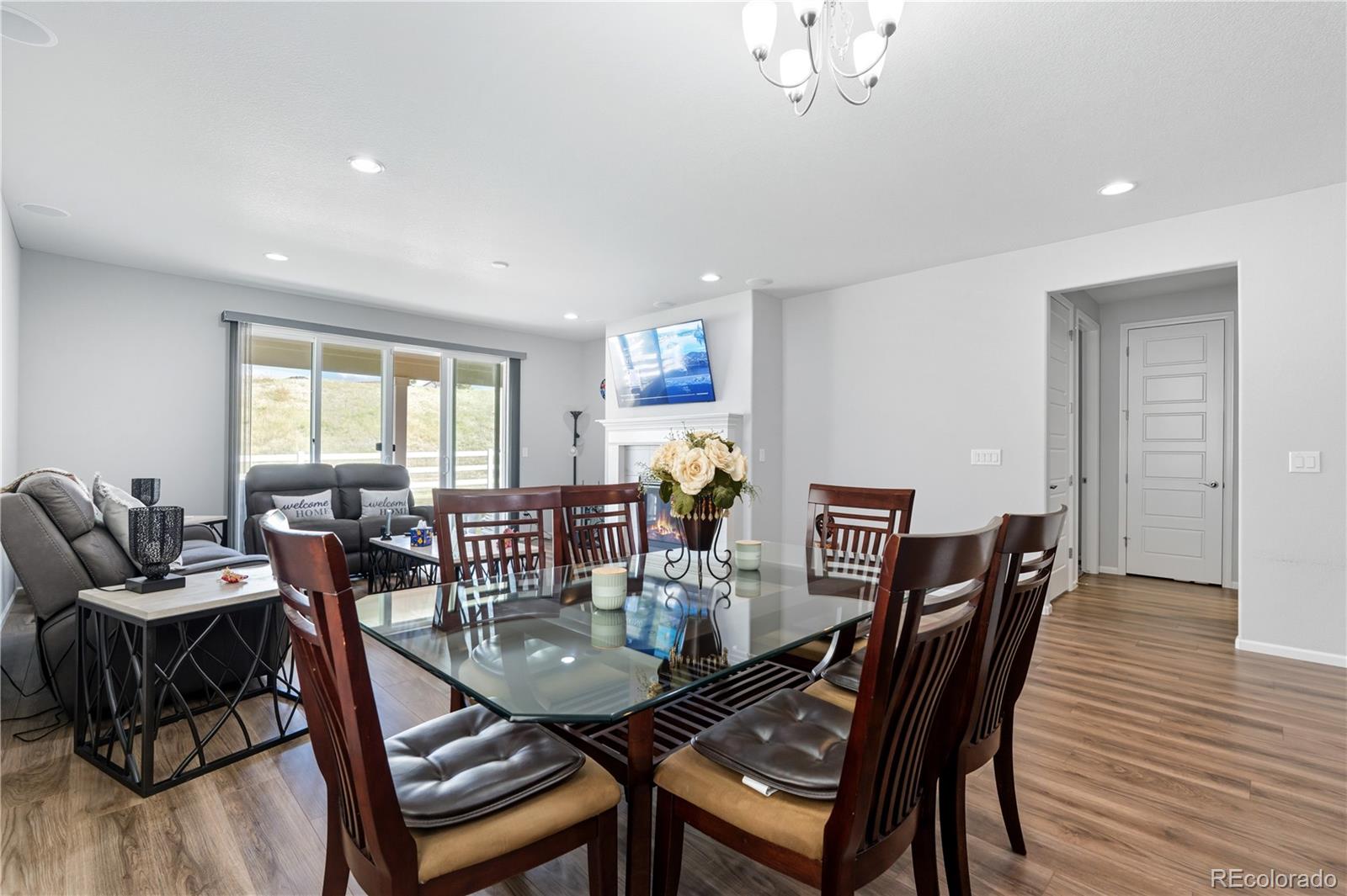 5740 Berry Ridge Wy. Castle Rock, CO 80104 - Photo 11 of 38 a view of a dining room with furniture window and wooden floor