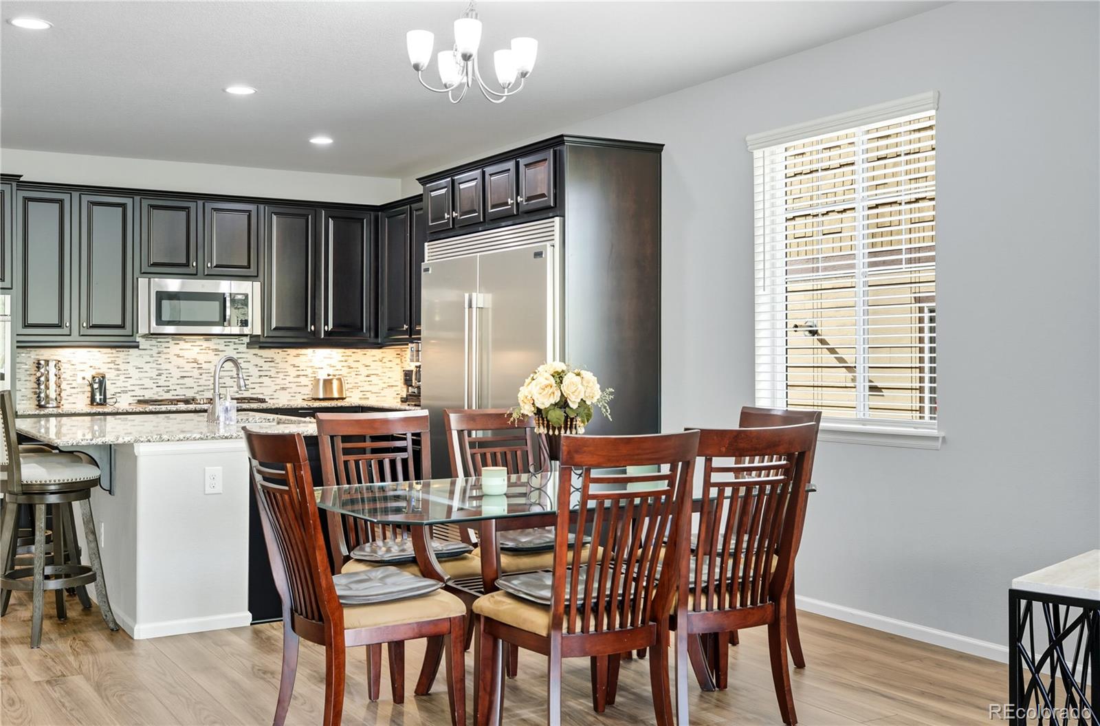5740 Berry Ridge Wy. Castle Rock, CO 80104 - Photo 14 of 38 a view of a dining room with furniture kitchen and wooden floor