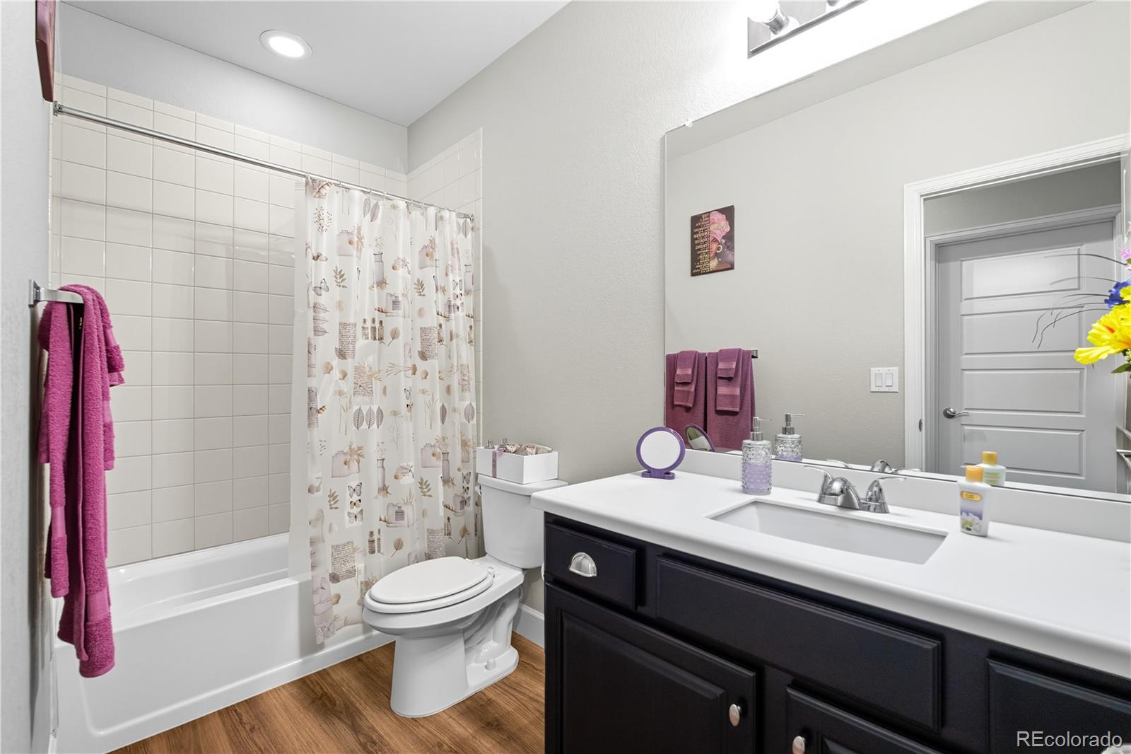 5740 Berry Ridge Wy. Castle Rock, CO 80104 - Photo 29 of 38 a bathroom with a sink a toilet and a large mirror