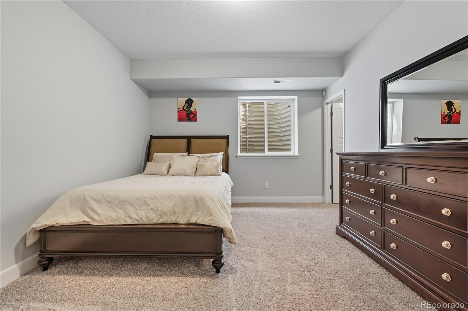 5740 Berry Ridge Wy. Castle Rock, CO 80104 - Photo 30 of 38 a bedroom with a bed and a dresser