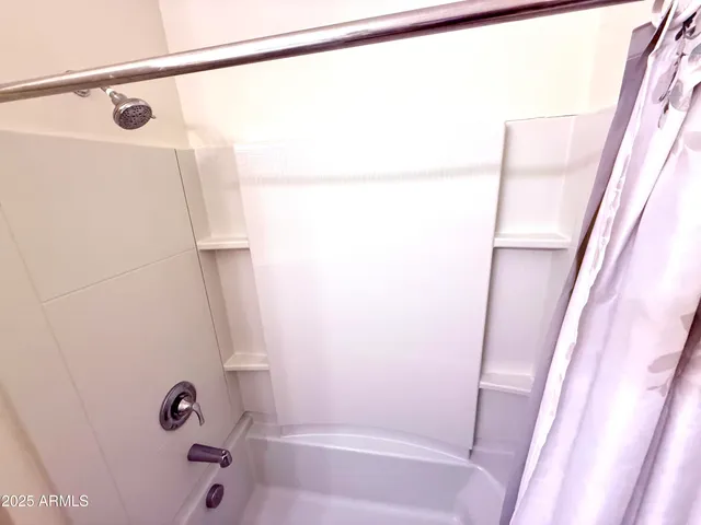 a bathroom with a shower and a tub