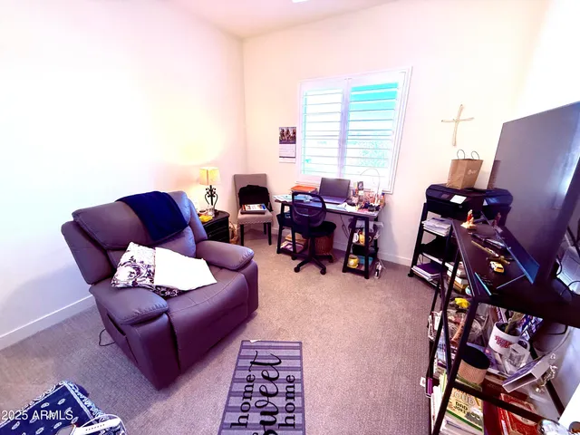 a living room with furniture a couch and a window