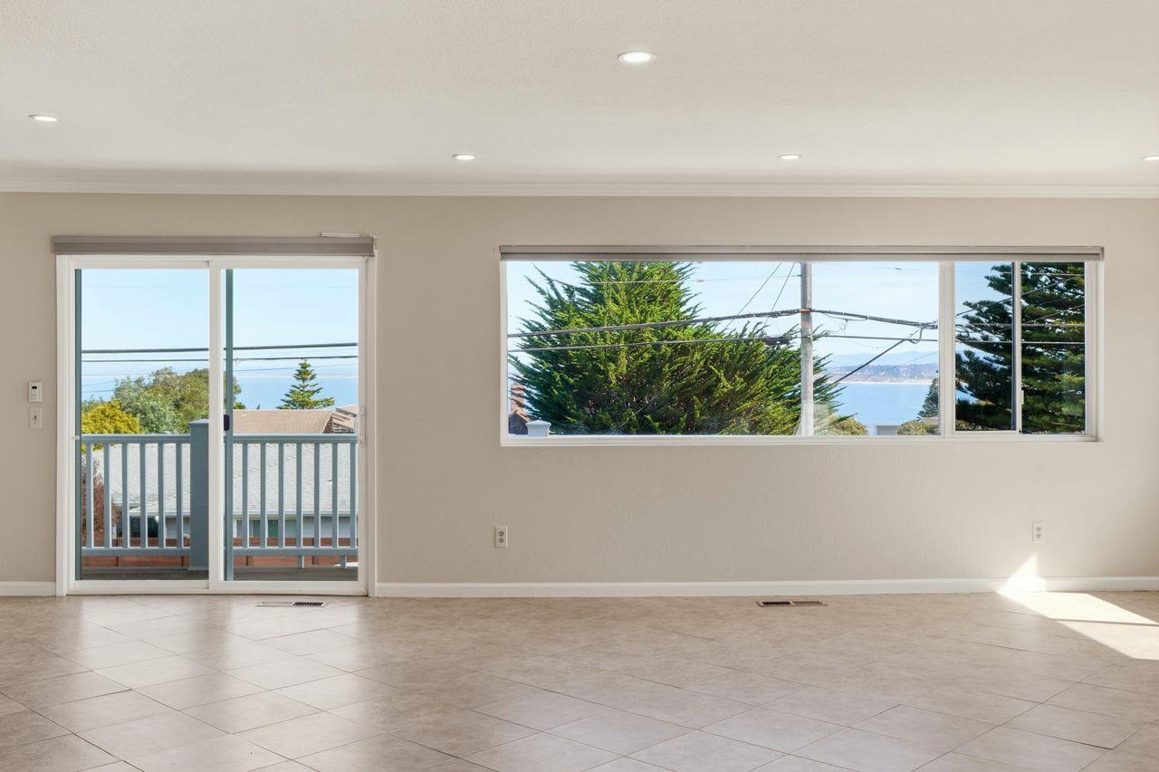 701 Archer Street Monterey, CA 93940 - Photo 13 of 39 a view of an empty room with wooden floor and a window
