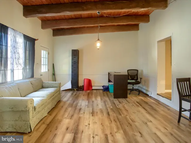 a kitchen with stainless steel appliances a refrigerator and wooden floor