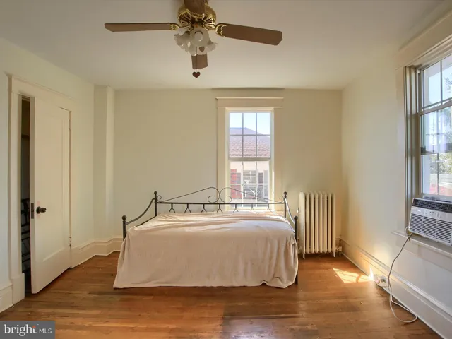 a spacious bedroom with a bed and a table