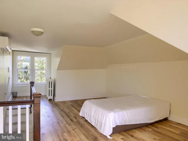 a room with wooden floor and window