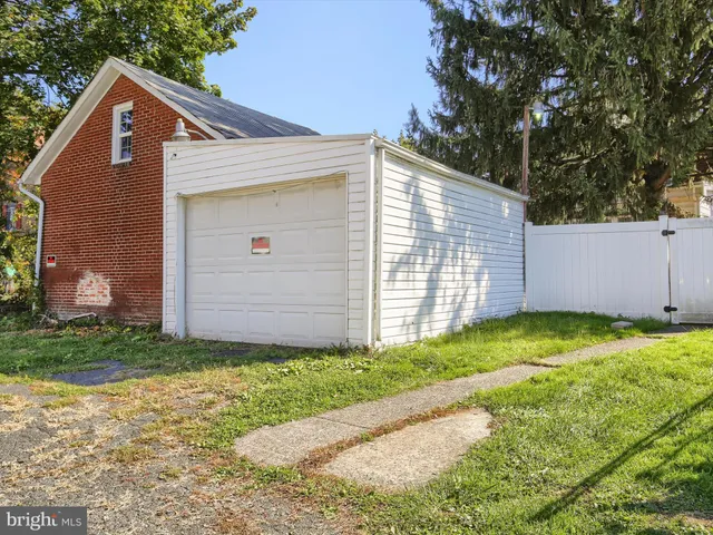 a view of backyard of house with garage