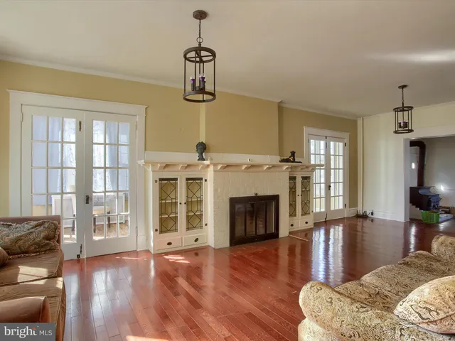 a living room with fireplace furniture and a large window