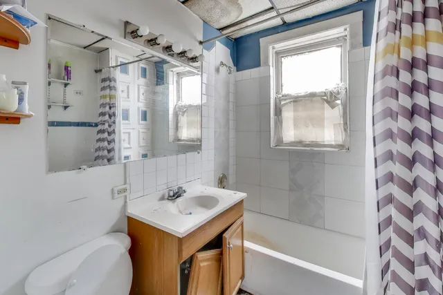 a bathroom with a sink toilet and shower