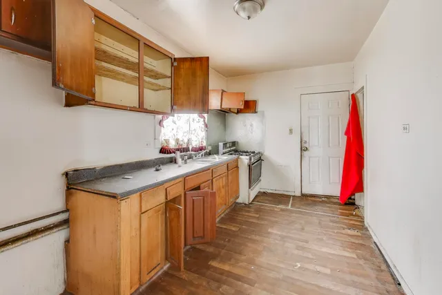 a kitchen with stainless steel appliances granite countertop a sink and a refrigerator