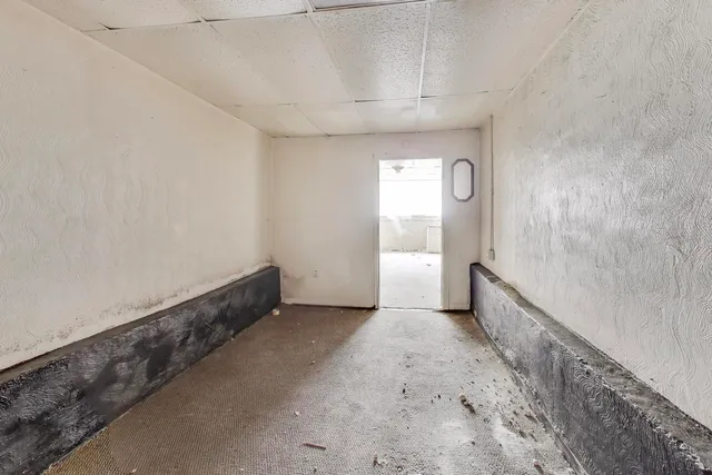 an empty room with a empty space and windows