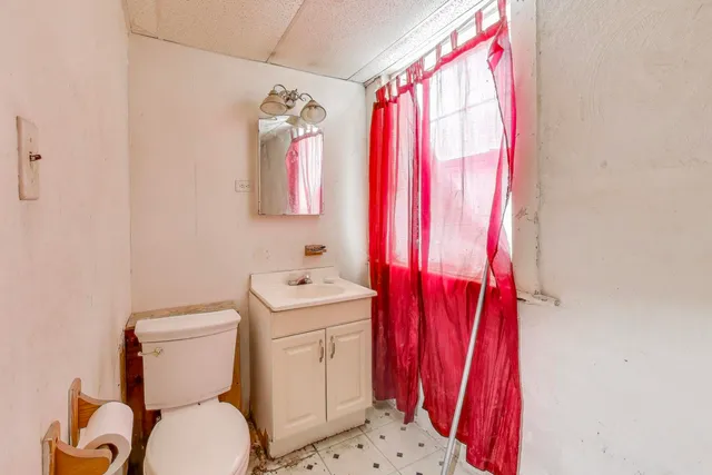 a picture of a room with a white wall and white cabinet