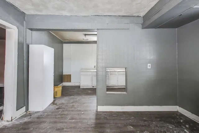 a view of a hallway with wooden shelves