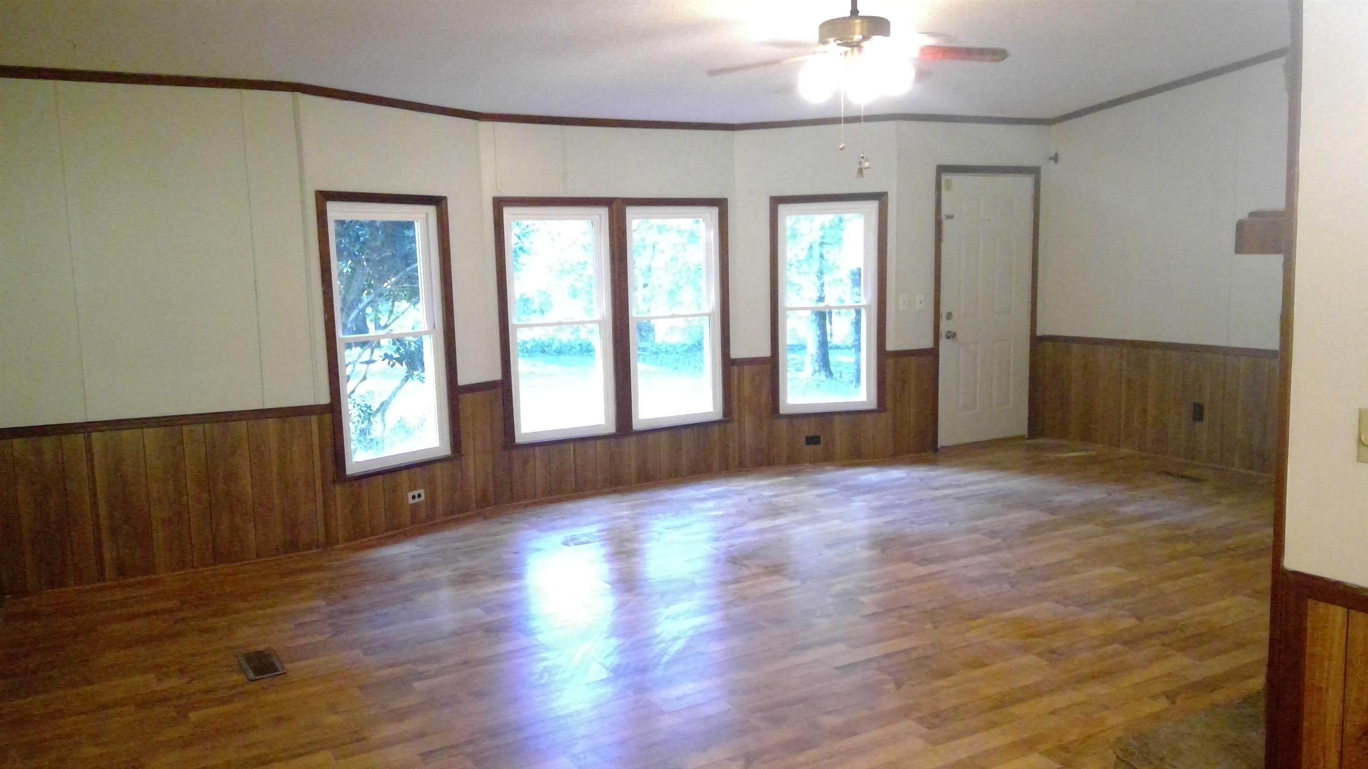 650 Canaan Road Columbia, TN 38401 - Photo 2 of 12 a view of an empty room with wooden floor and a window