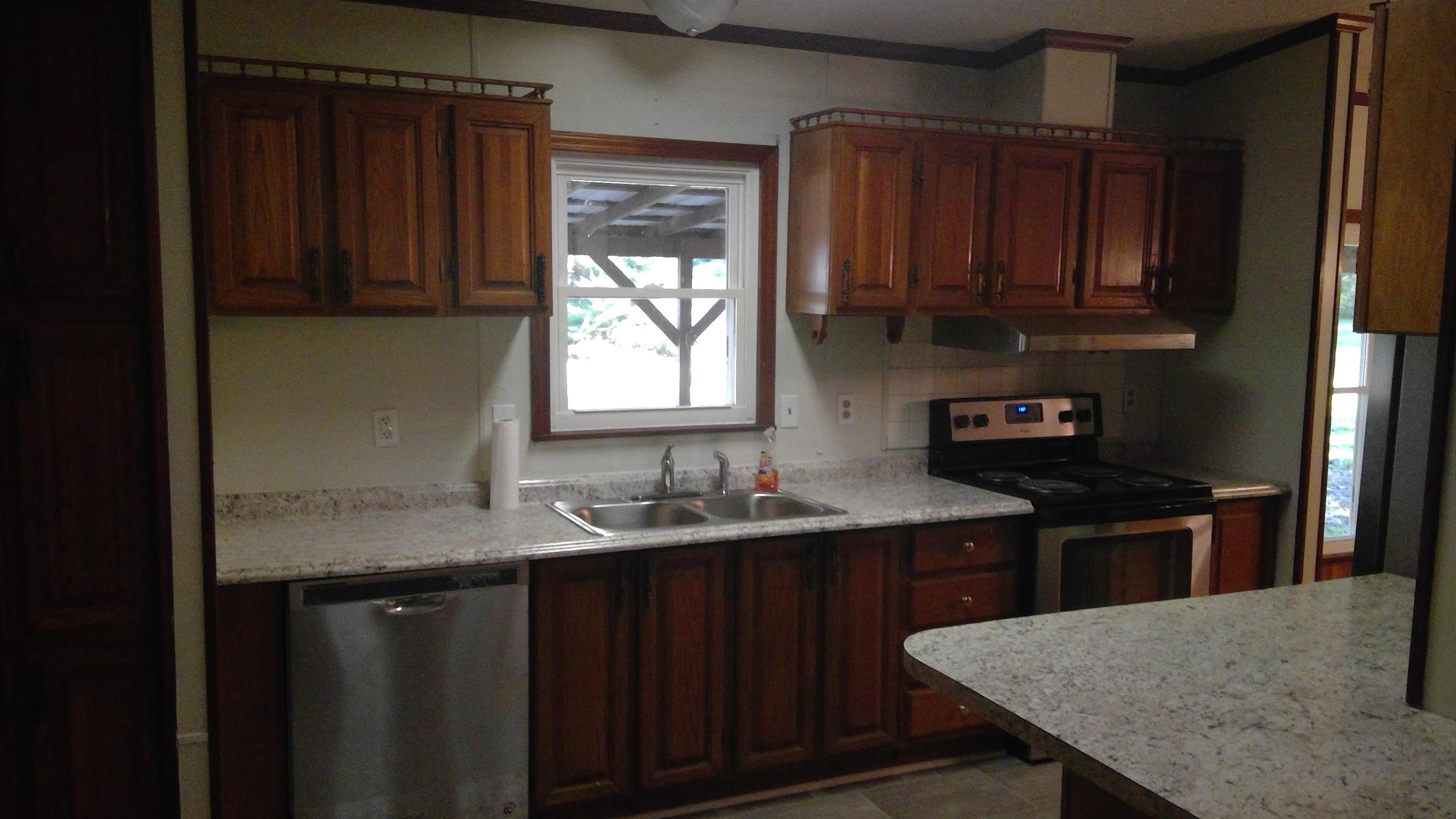 650 Canaan Road Columbia, TN 38401 - Photo 6 of 12 a kitchen with granite countertop stainless steel appliances a sink a stove a counter space and cabinets