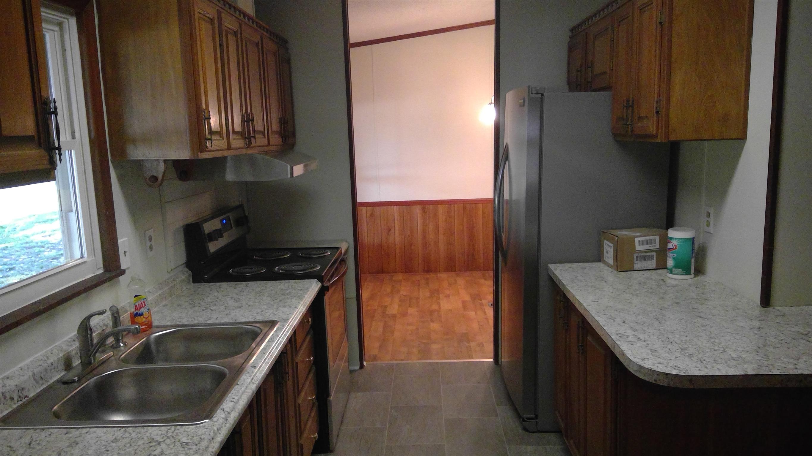 650 Canaan Road Columbia, TN 38401 - Photo 7 of 12 a kitchen with stainless steel appliances granite countertop a sink stove and refrigerator