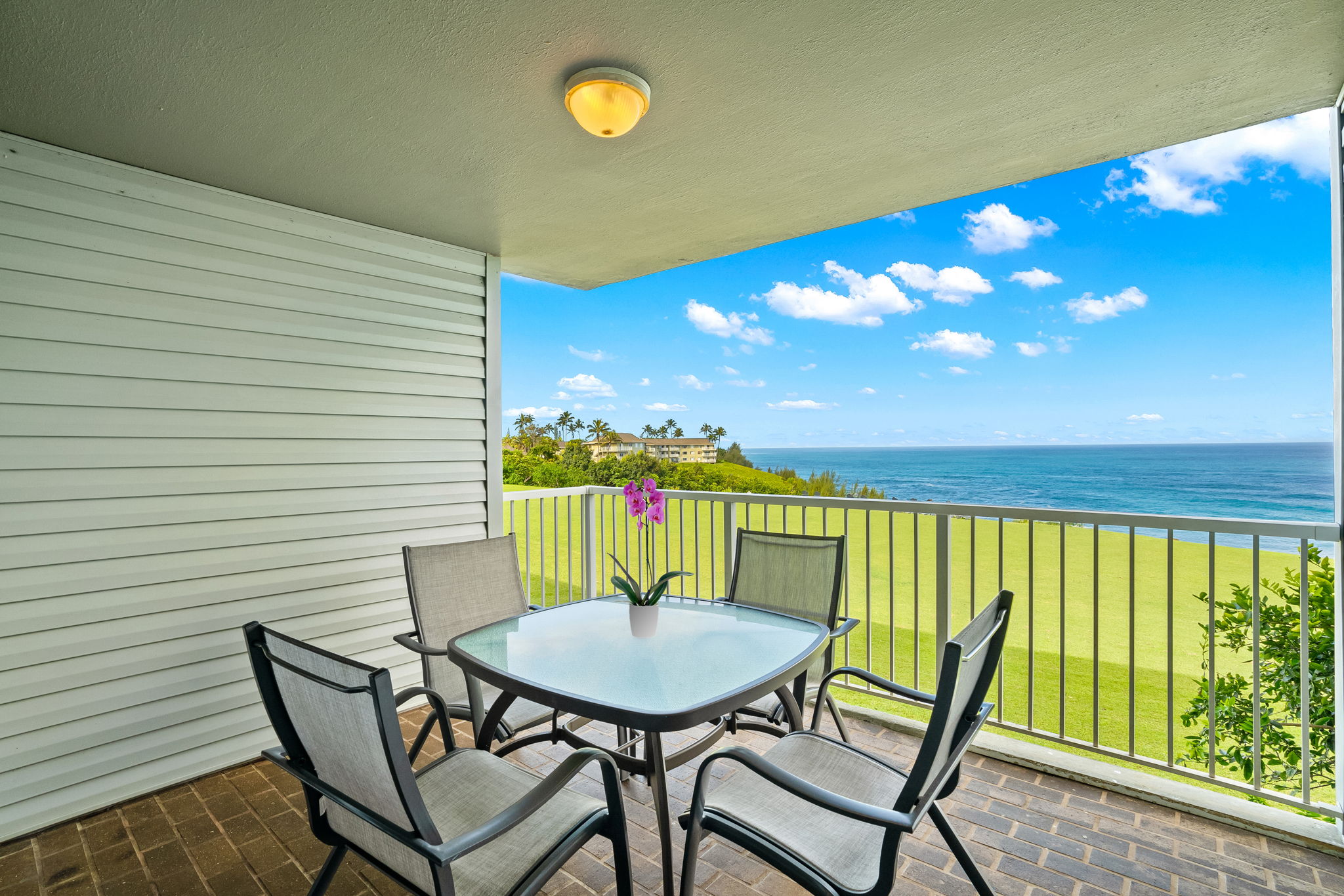 a view of a balcony with table and chairs